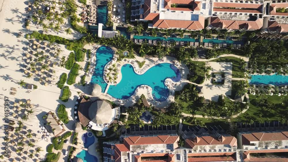 Aerial view of tropical resort with swimming pool area, family fun in vacation, Punta Cana in Dominican Republic, all inclusive travel and leisure. Sunset. Top view