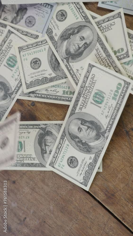 Floating dollars covering a wooden table Floating dollars covering a wooden table