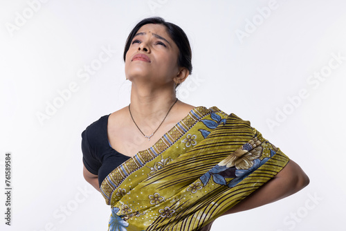 Canvas Print Indian woman suffering with lower back pain at white background.