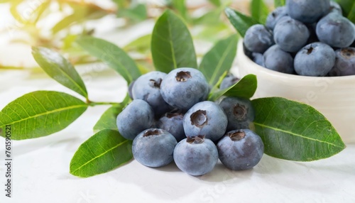Close-up of raw blueberry fruits with leaves on white floor, South Korea . 