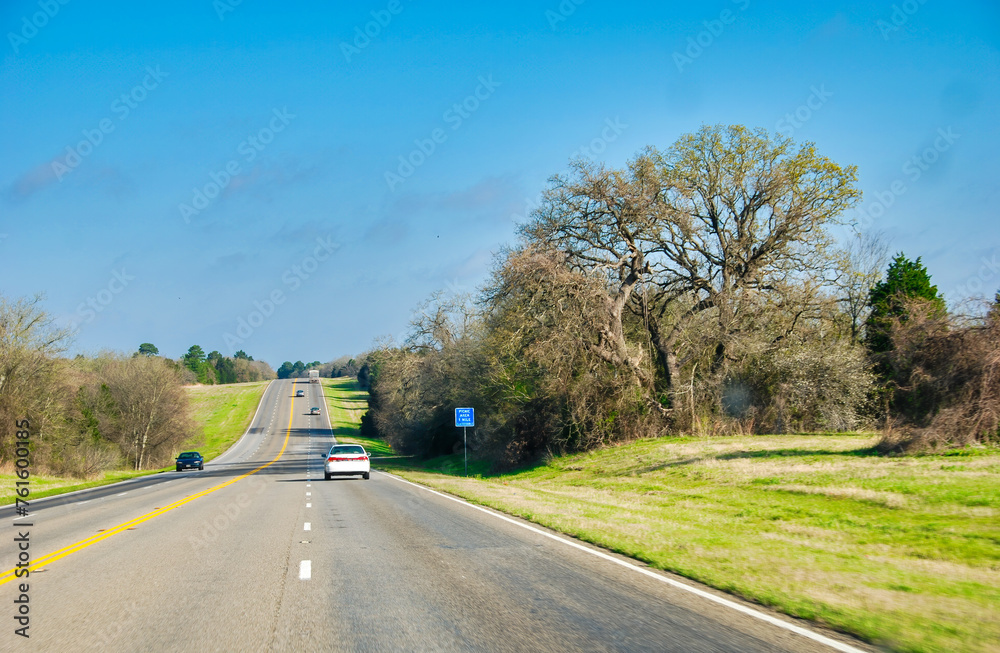 Traffic along Texas countryside road in spring season