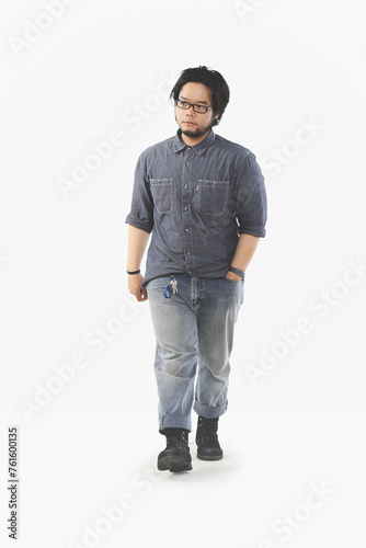 full body portrait of an Asian man wearing glasses walking on a white background