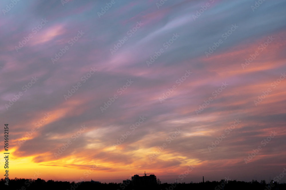 Gray-blue gloomy dull sky at sunset, evening twilight, silhouette of the city on the horizon