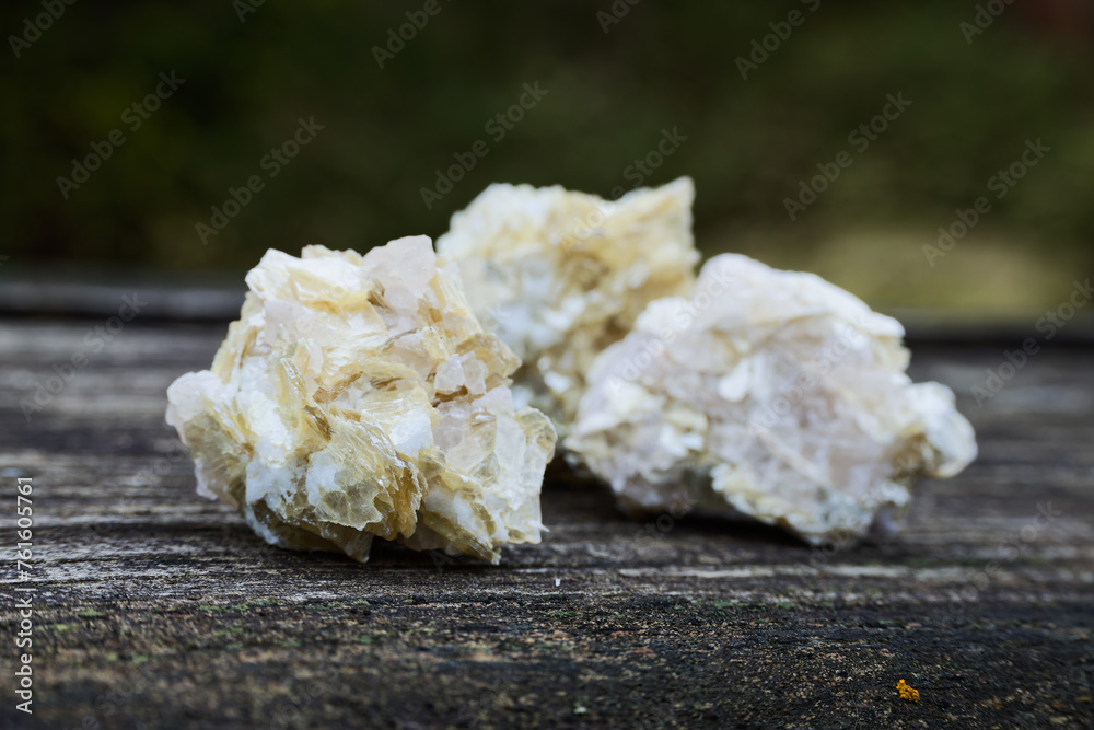 Golden mica raw crystal stones mineral on wooden rustic table. Golden mica raw crystal stones mineral on wooden rustic table.