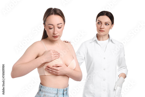 Woman doing breast self-examination during mammologist's appointment on white background © New Africa