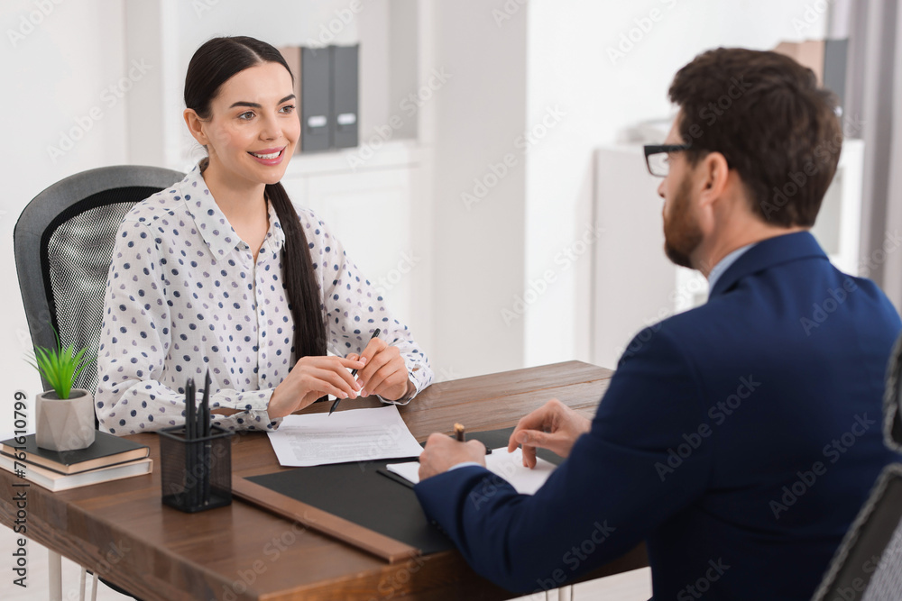 Woman having meeting with lawyer in office, selective focus Woman having meeting with lawyer in office, selective focus