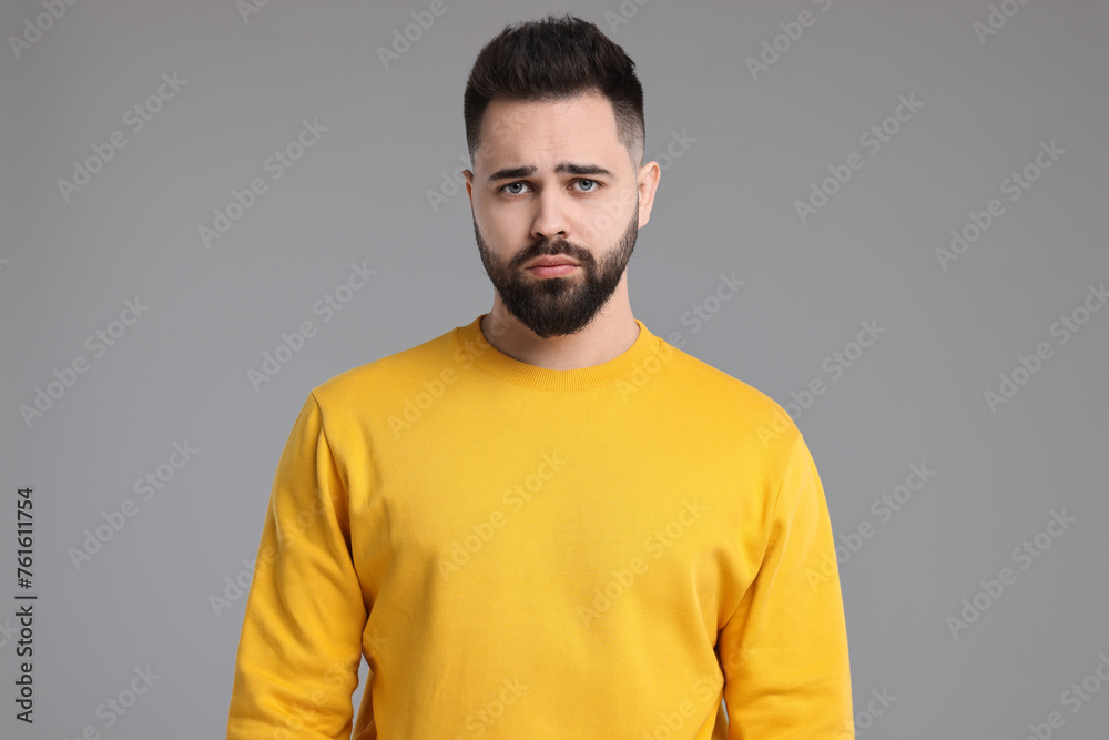 Portrait of sad man on light grey background Portrait of sad man on light grey background