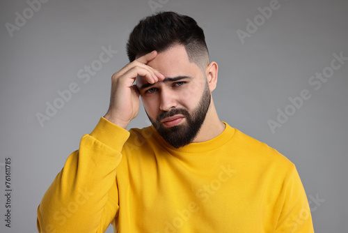 Portrait of sad man on light grey background
