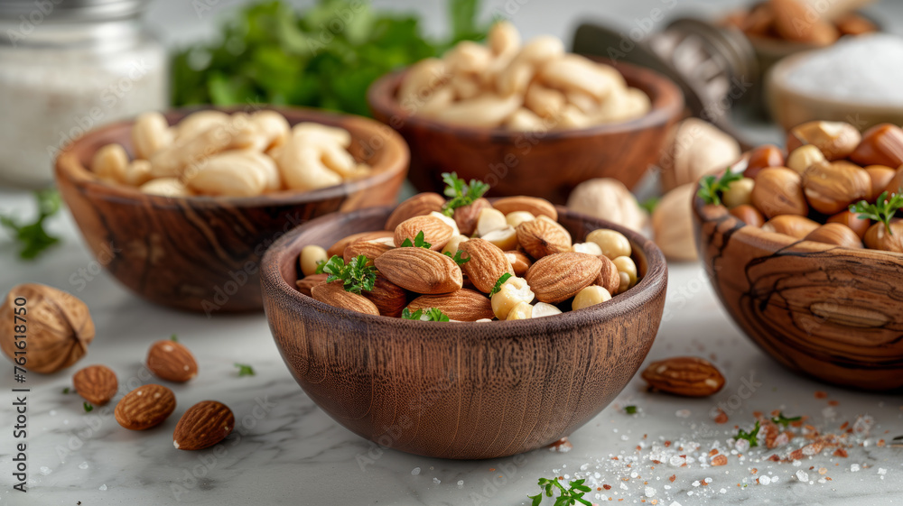 Three bowls with almonds and cashews on a table Three bowls with almonds and cashews on a table