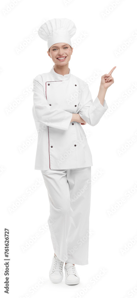 Happy woman chef in uniform pointing at something on white background