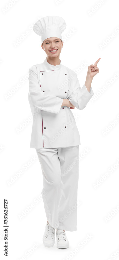 Happy woman chef in uniform pointing at something on white background Happy woman chef in uniform pointing at something on white background