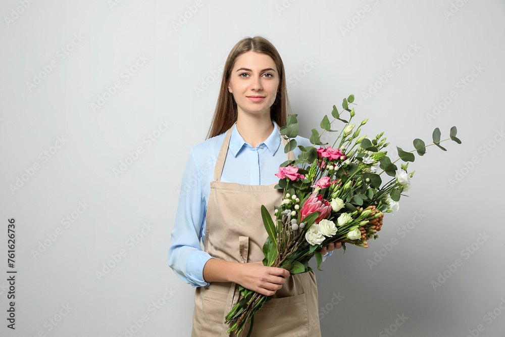 Florist with beautiful bouquet on light background Florist with beautiful bouquet on light background