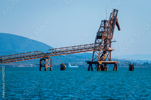 a view of an industrial bridge and harbor from the water