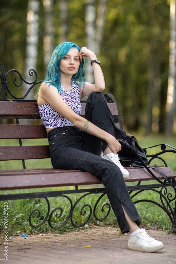 Portrait of a young beautiful slender girl with blue hair. Portrait of a young beautiful slender girl with blue hair.