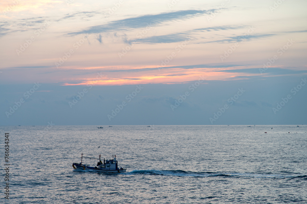 View of the fishing boat during sunrise View of the fishing boat during sunrise