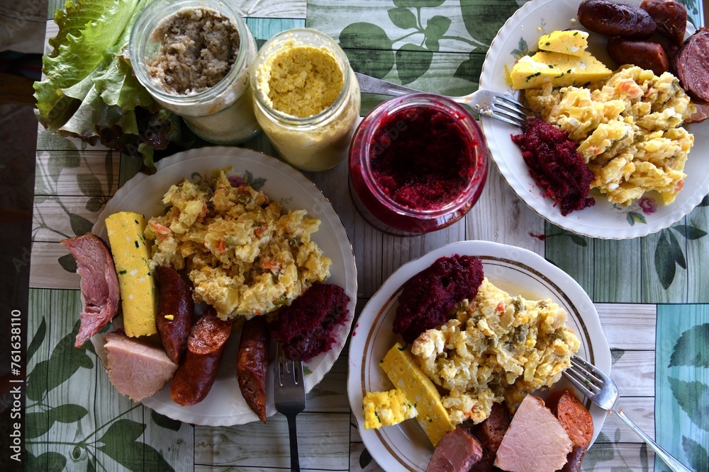 Eating traditional easter food with salad, ham eggs, beetroot and horseradish