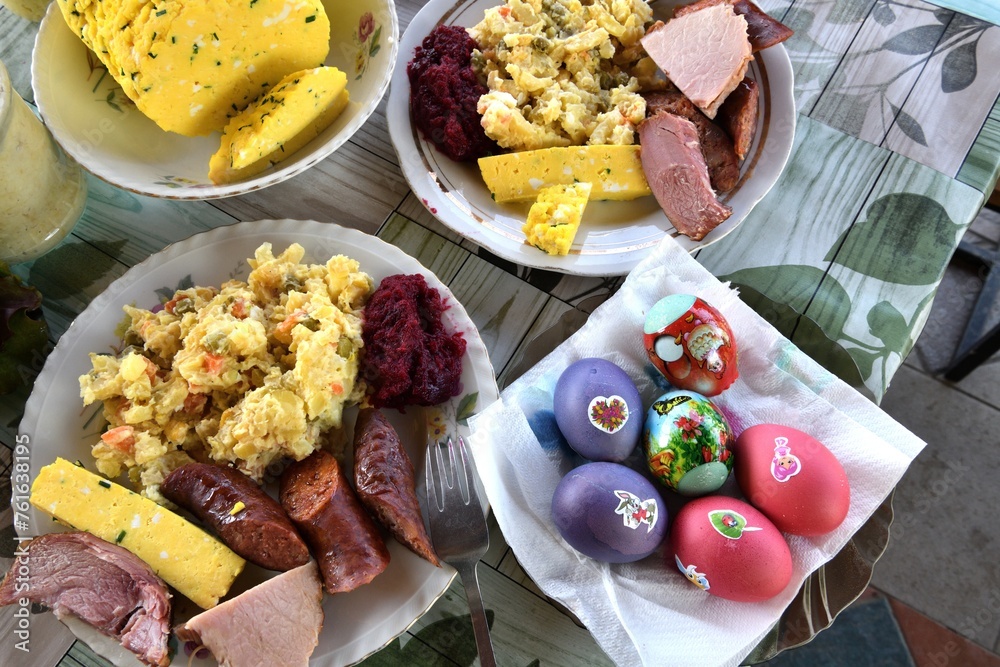 Easter table with salad, eggs, ham, sausage, beetroot and horseradish