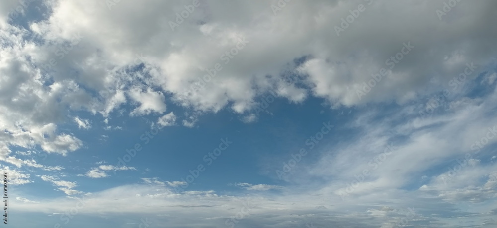 Russia. South of Western Siberia. Panorama of the daytime summer sky with cumulus clouds over the fields of Kuznetsk Alatau.
