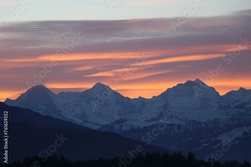 Fototapeta Naklejka Na Ścianę i Meble -  Orange sunset over Eiger Monch and Jungfrau