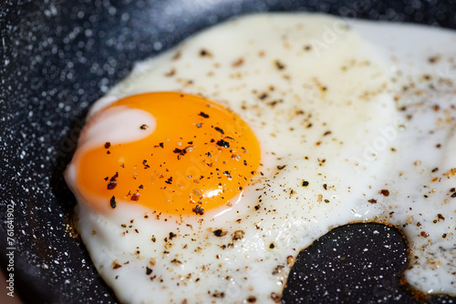 fried egg in a frying pan, breakfast preparation