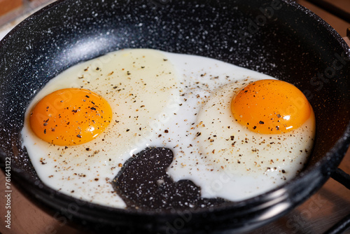 two fried eggs in a frying pan