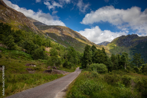 Glen Nevis road in the middle of a forest in Fort William, Scotland, on a summer day. The route that will take you to Steall Waterfall photo