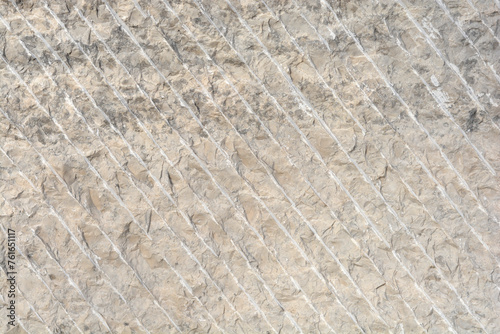 Detail of carved stone surface with parallel lines
