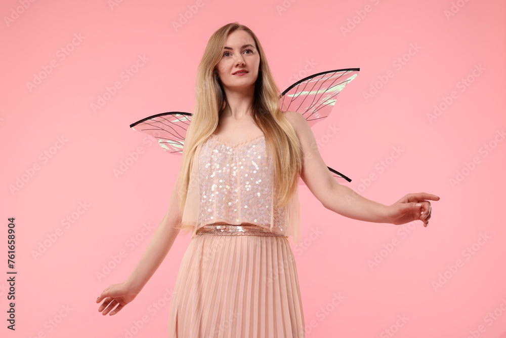 Beautiful girl in fairy costume with wings on pink background Beautiful girl in fairy costume with wings on pink background
