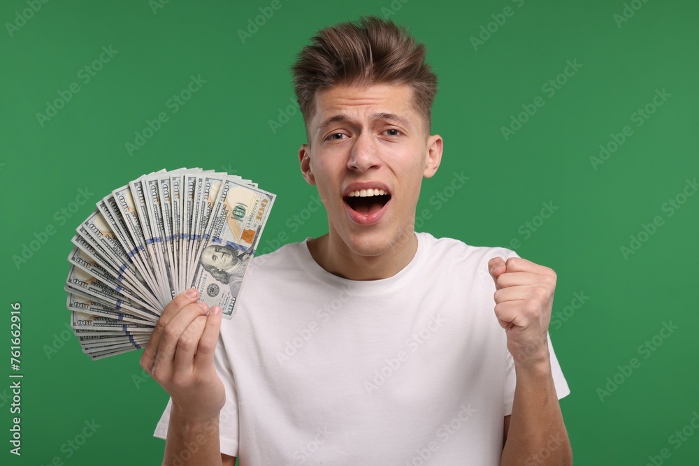 Handsome man with dollar banknotes on green background Handsome man with dollar banknotes on green background