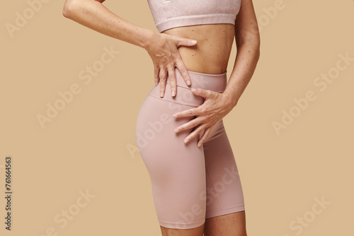 Cropped image of woman showing off her toned and tight thighs and butt