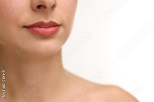 Woman with beautiful lips on white background, closeup. Space for text