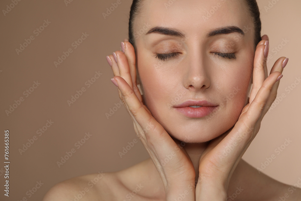 Beautiful young woman with healthy skin on light brown background, closeup. Space for text Beautiful young woman with healthy skin on light brown background, closeup. Space for text