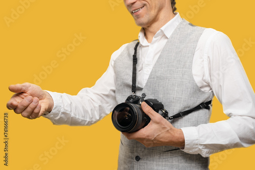 Young photographer getting payment for photo session on yellow background, harmonious blend of technical expertise, artistic vision, and the pursuit of economic stability.