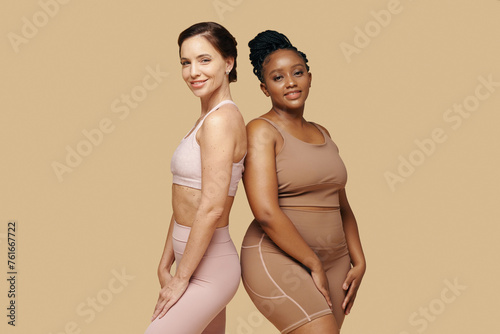 Smiling slim and curvy women standing next to each other