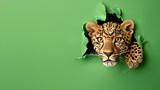 A sharp depiction of a leopard's face pushing through green paper, illustrating the concept of breaking barriers