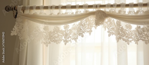 A white curtain with a lace trim is hanging on a window, adding a touch of elegance to the room. The window treatment complements the wood flooring and glass windows photo