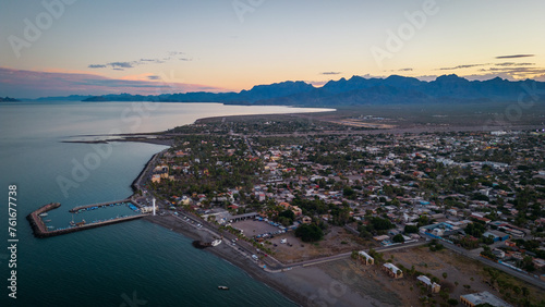 drone fly above Loreto Baja California Sur Mexico old colonial town with sea gulf ocean and mountains desert landscape at sunset © Michele