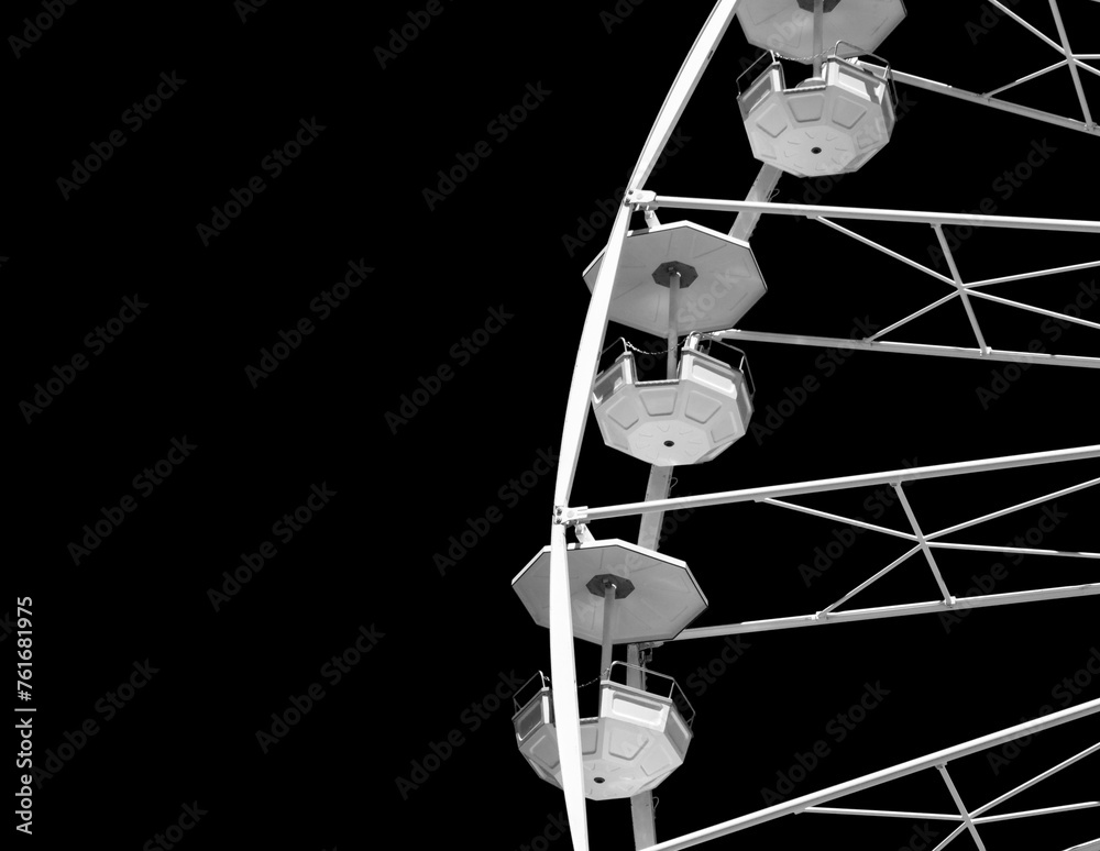 White ferris wheel on the black background. Copy space. Close-up.