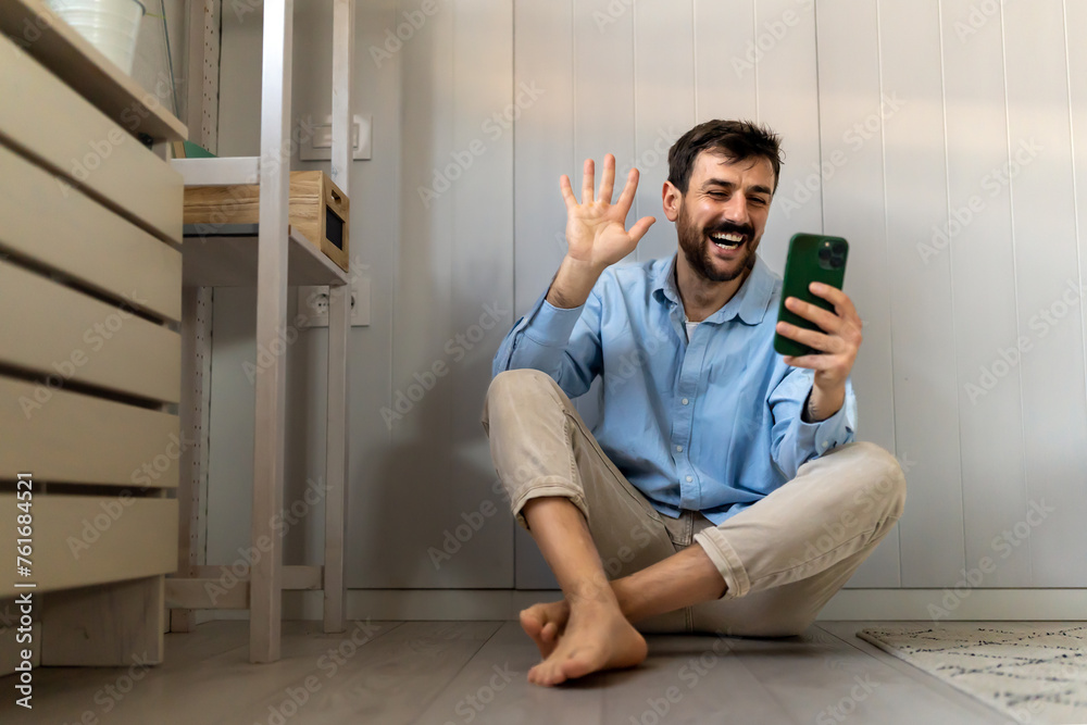 Young man using cellphone for work, social media or relaxation. Smart phone people concept.
