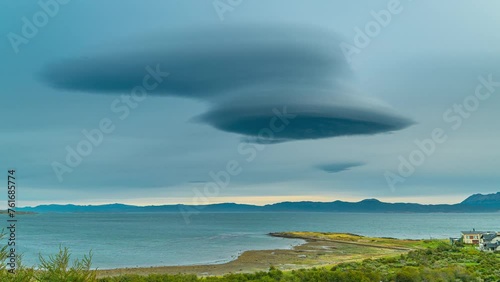Timelapse of Lenticular clouds over sea with mountains on Beagle canal in Tierra del Fuego, Argentina and Chile. photo