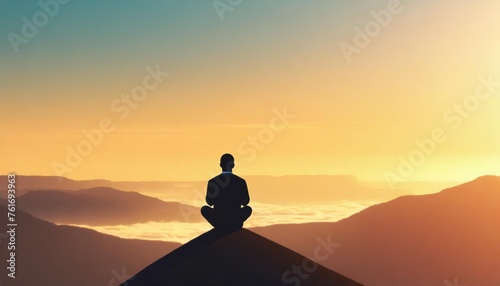 Silhouette of a man meditating in a lotus position at sunrise in the mountains, symbolizing peace and spirituality. © Red Lemon