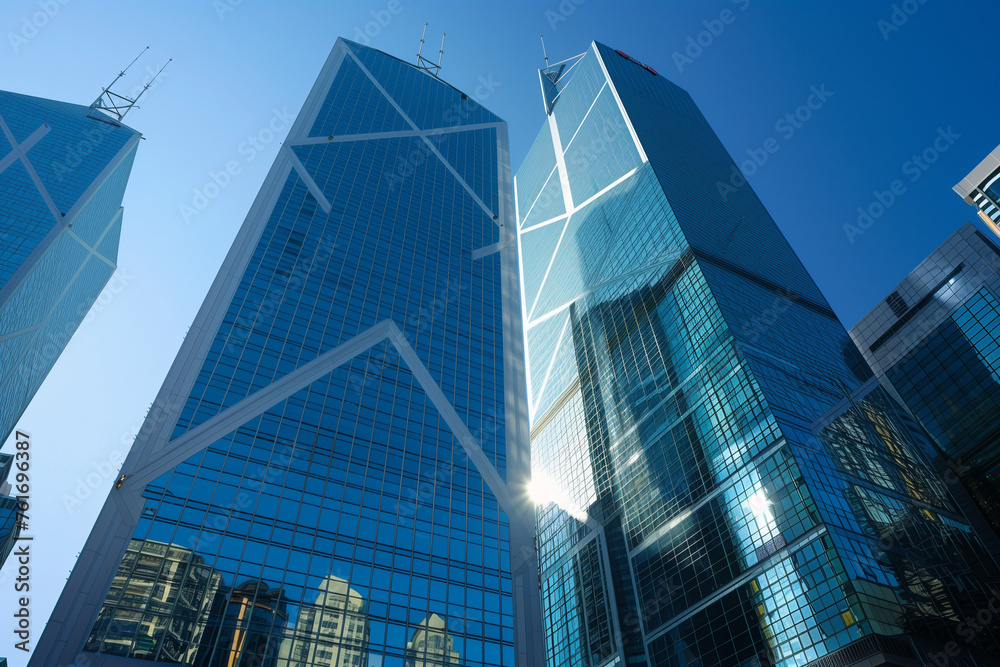 A modern Hong Kong skyscraper reflects the city's energy with its glass facade and intricate details against a clear blue sky