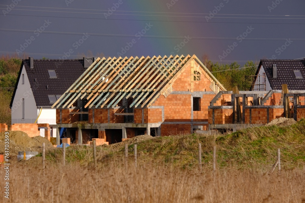 A housing estate of single-family houses under construction. Roof construction. A housing estate of single-family houses under construction. Roof construction.