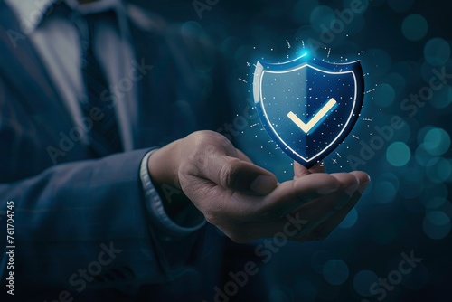 Hand holding virtual shield with check mark, cyber virtual security and digital security, data protection. Cyber hidden concept on blurred business man. 
