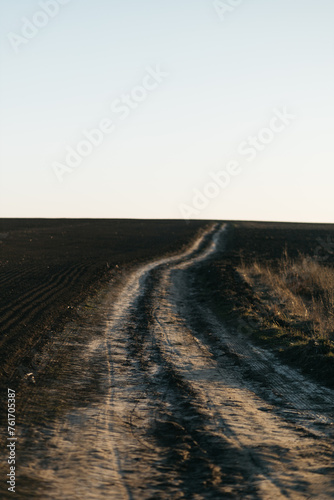 a dirt road in the field that leads to nowhere