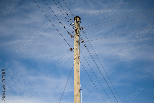 Old style electricity line with old equipment on blue sky background