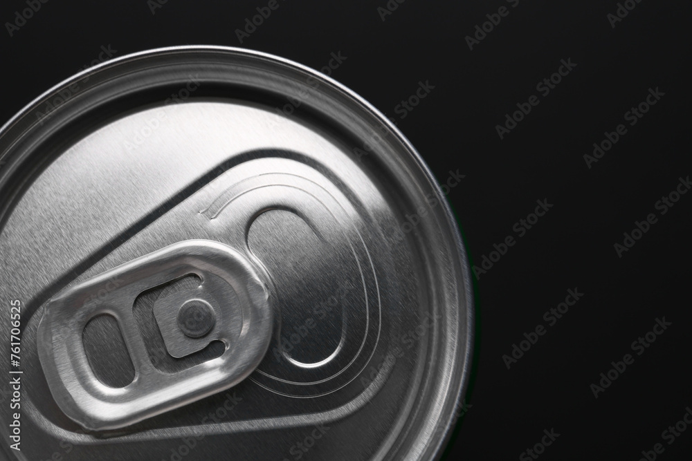 Energy drink in can on black background, top view. Space for text Energy drink in can on black background, top view. Space for text