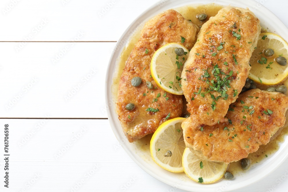 Delicious chicken piccata on white wooden table, top view. Space for text Delicious chicken piccata on white wooden table, top view. Space for text