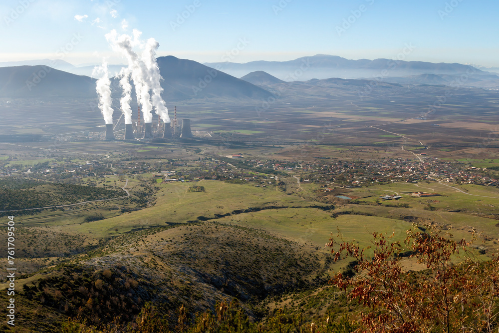 Power plant operating among green fields in the plain region of Ptolemaida, the