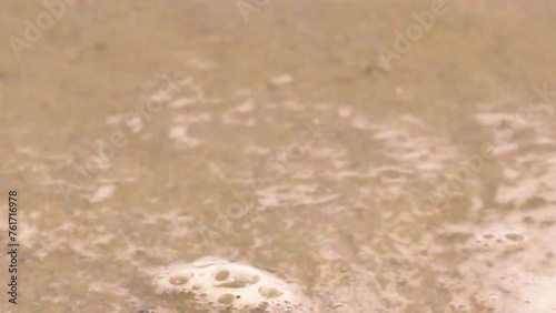 The waves crashing on the beach.
